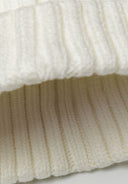Cream baby rib beanie with pom pom, crafted from soft knitted rib construction for snug warmth, size 0-24m.