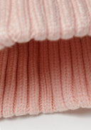 Soft pink rib knit texture of baby rib beanie with pom pom pink 0-24m, designed for warmth and comfort.