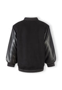 Boys black baseball jacket with faux leather sleeves and ribbed trim