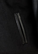 Boys black baseball jacket with faux leather sleeves and black leather zipper pocket