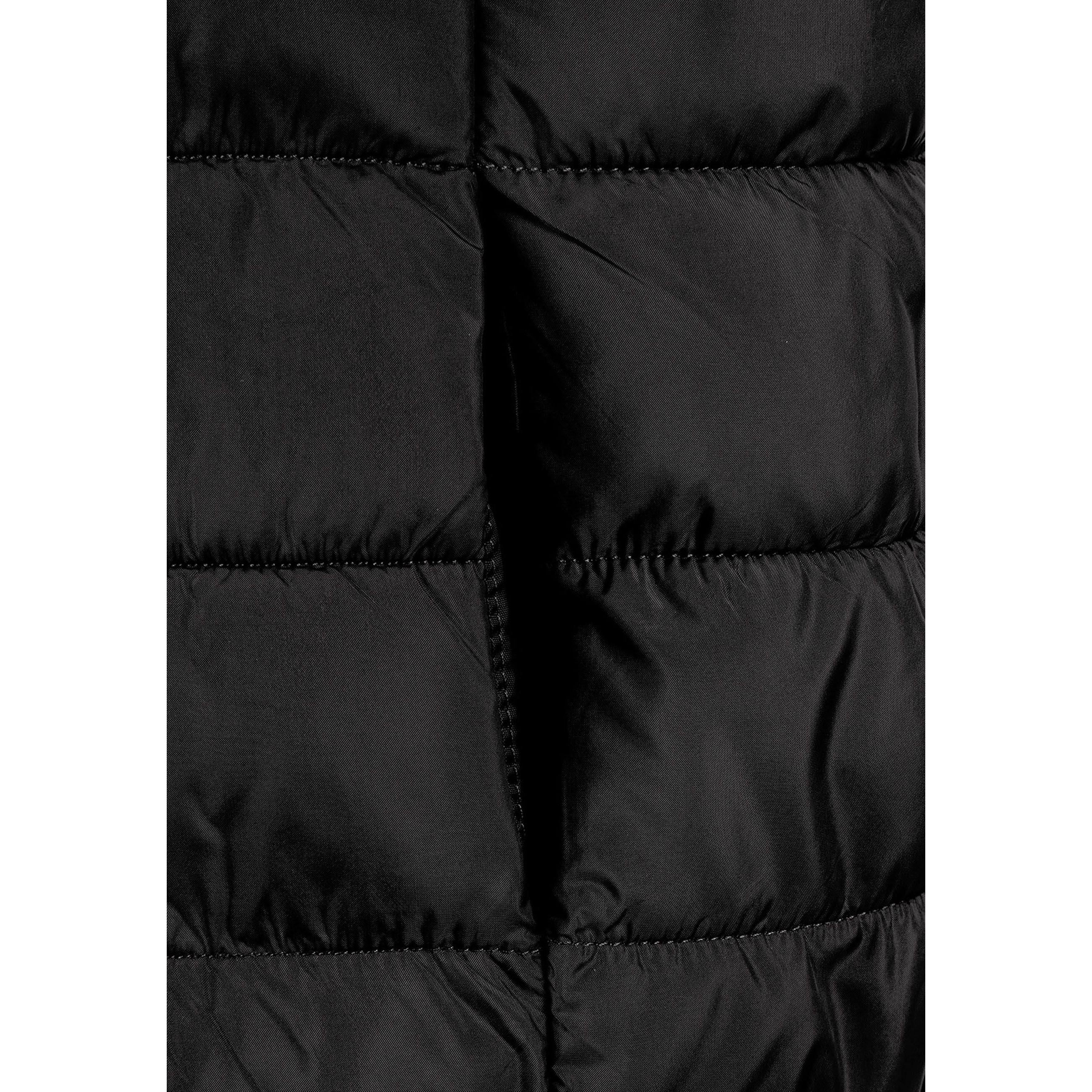 Detail view of black padded gilet front zipper and quilted chest panel construction