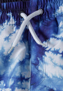 Boys board shorts all-over print navy 3-14y featuring a vibrant blue tie-dye pattern with a comfortable elastic waistband and adjustable drawstring.