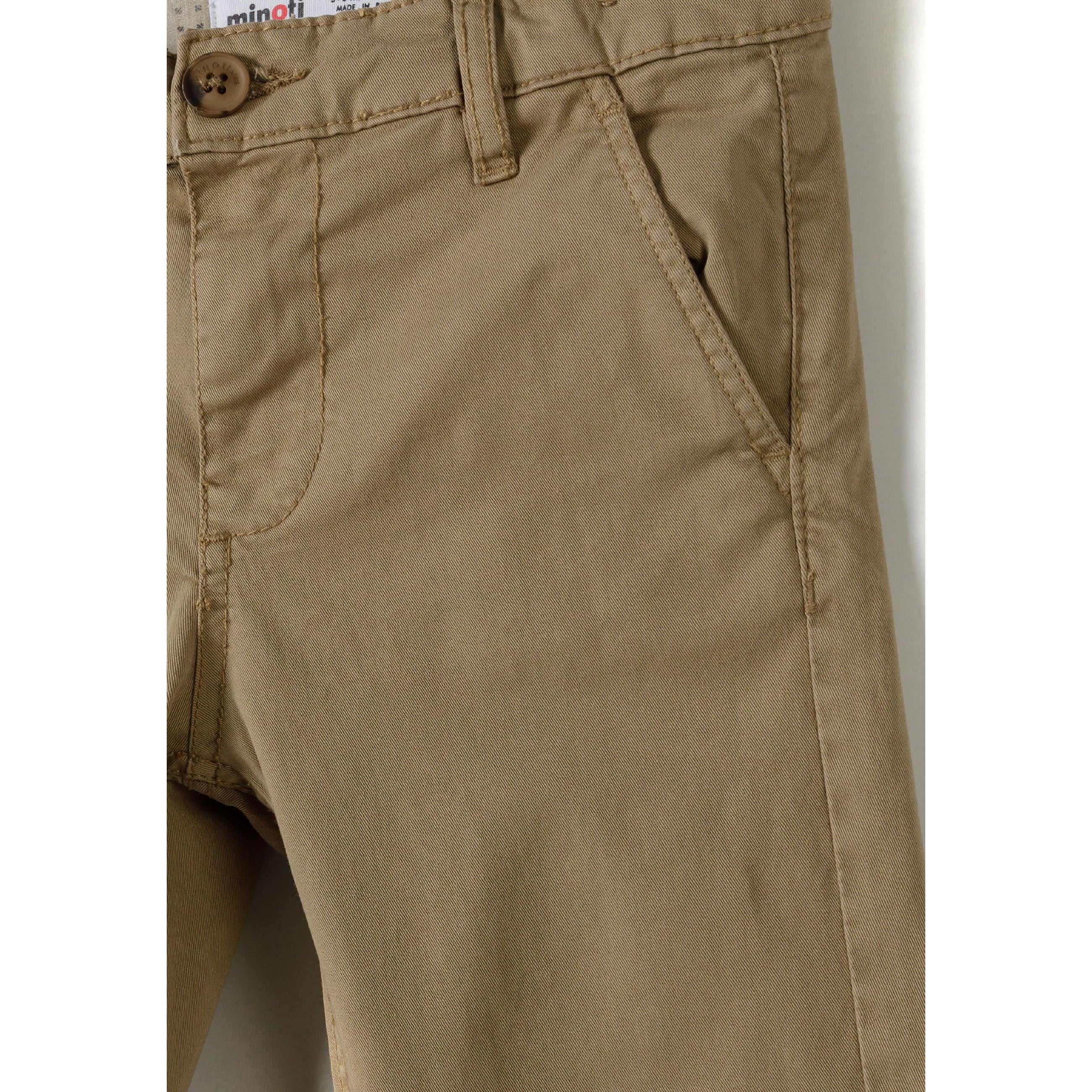 Close-up detail of beige chino trouser waistband showing Minoti label, button fastening and front pocket with clean stitching