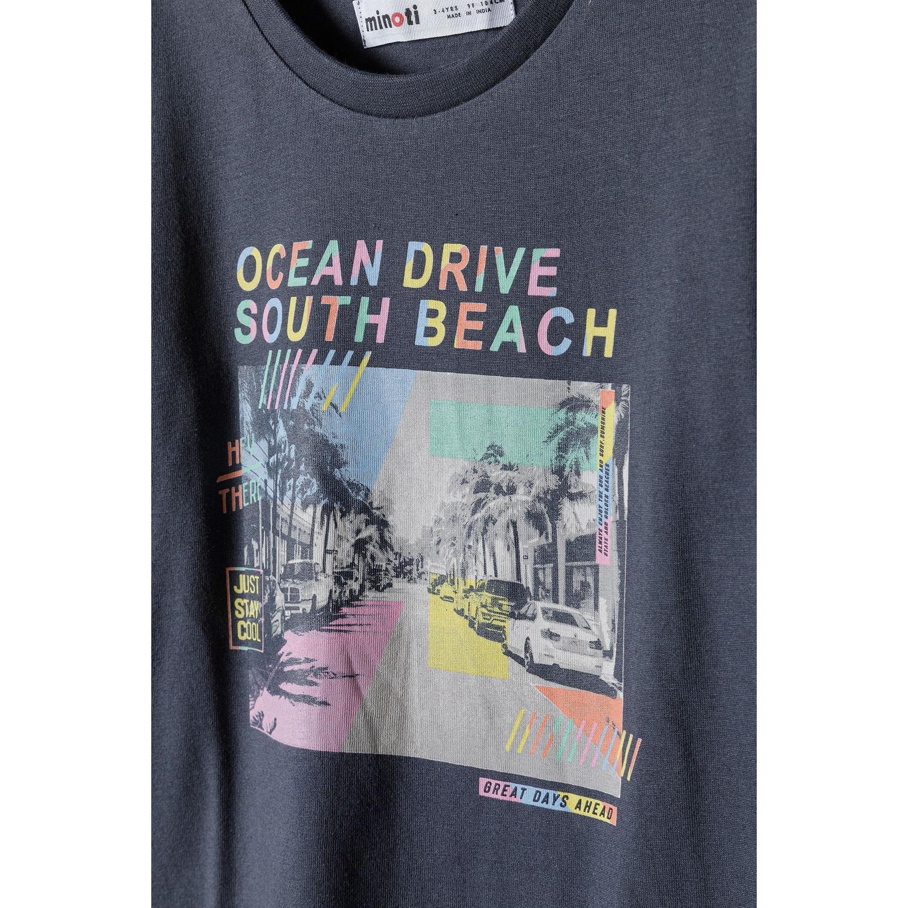 Close-up detail of Ocean Drive South Beach print with colorful street scene and Minoti label visible