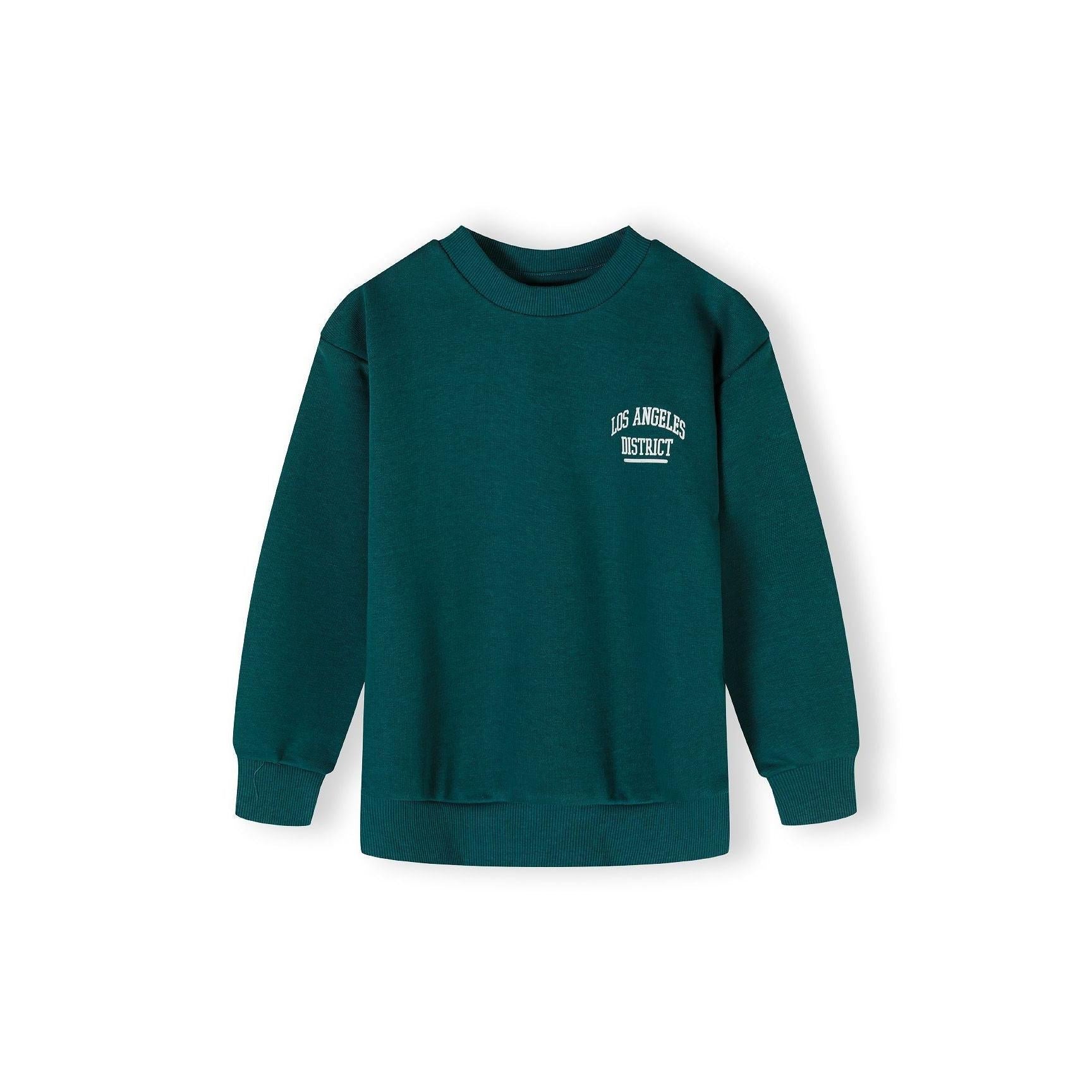 Close-up detail of dark green joggers showing elasticated waistband with drawstring and Los Angeles District white text print