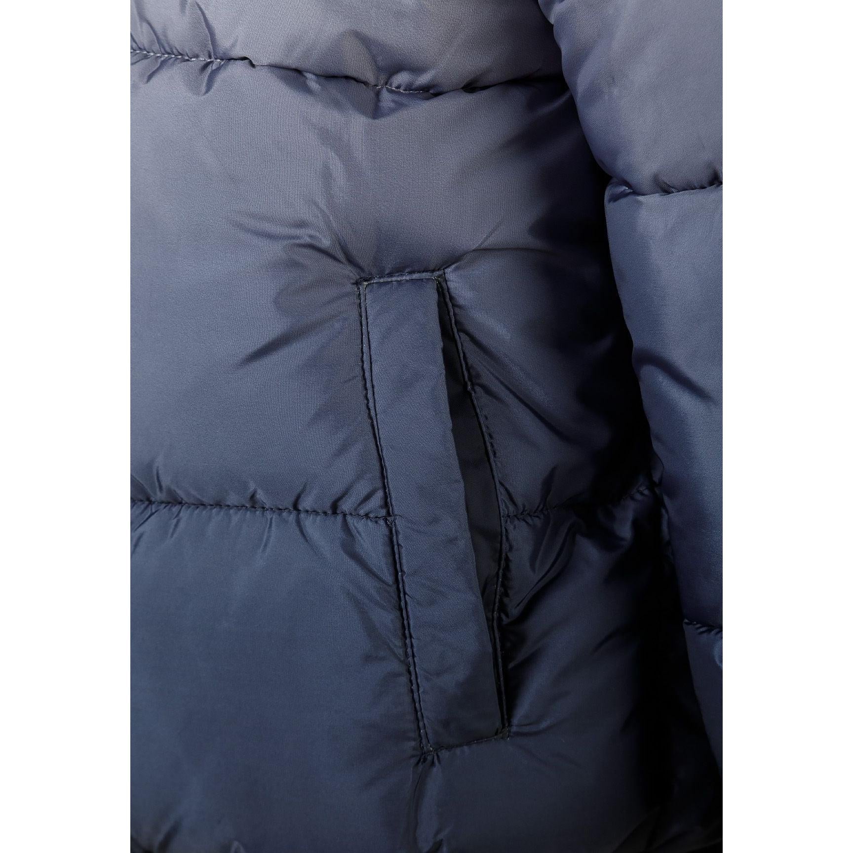 Close-up detail of grey ombré padded jacket showing front pocket with black zip trim and quilted padding texture on darker lower section