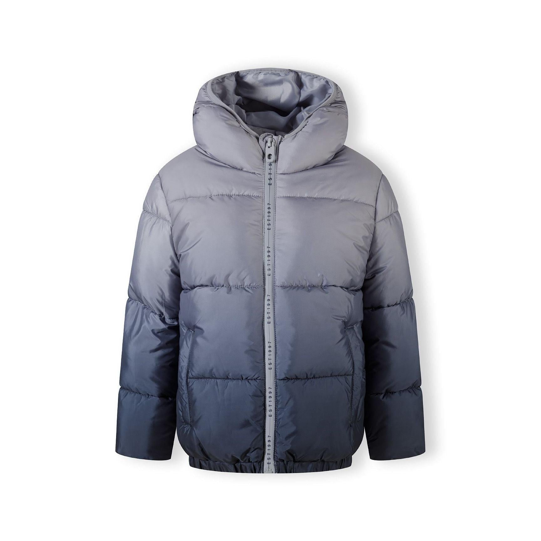 Grey ombré padded jacket laid flat showing front view with hood, zip closure, Minoti label visible at neck, displaying gradient color transition from light to dark