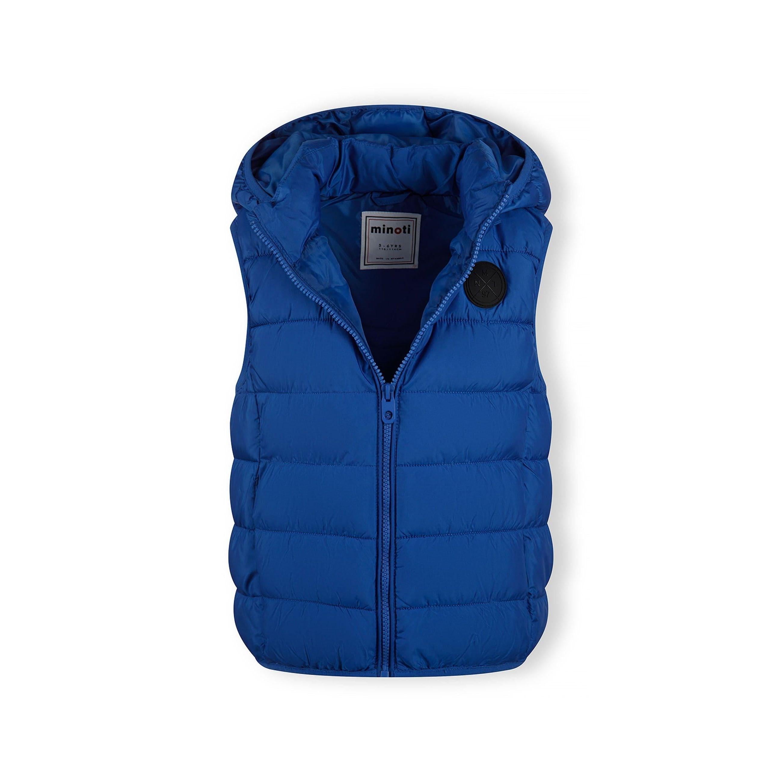 Flat lay of cobalt blue padded gilet showing detachable hood and quilted construction against white background