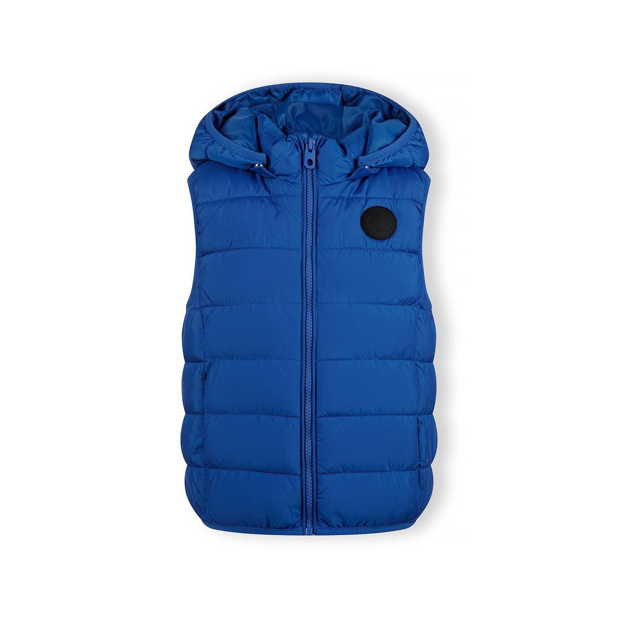 Flat lay of cobalt blue padded gilet showing detachable hood and quilted construction against white background