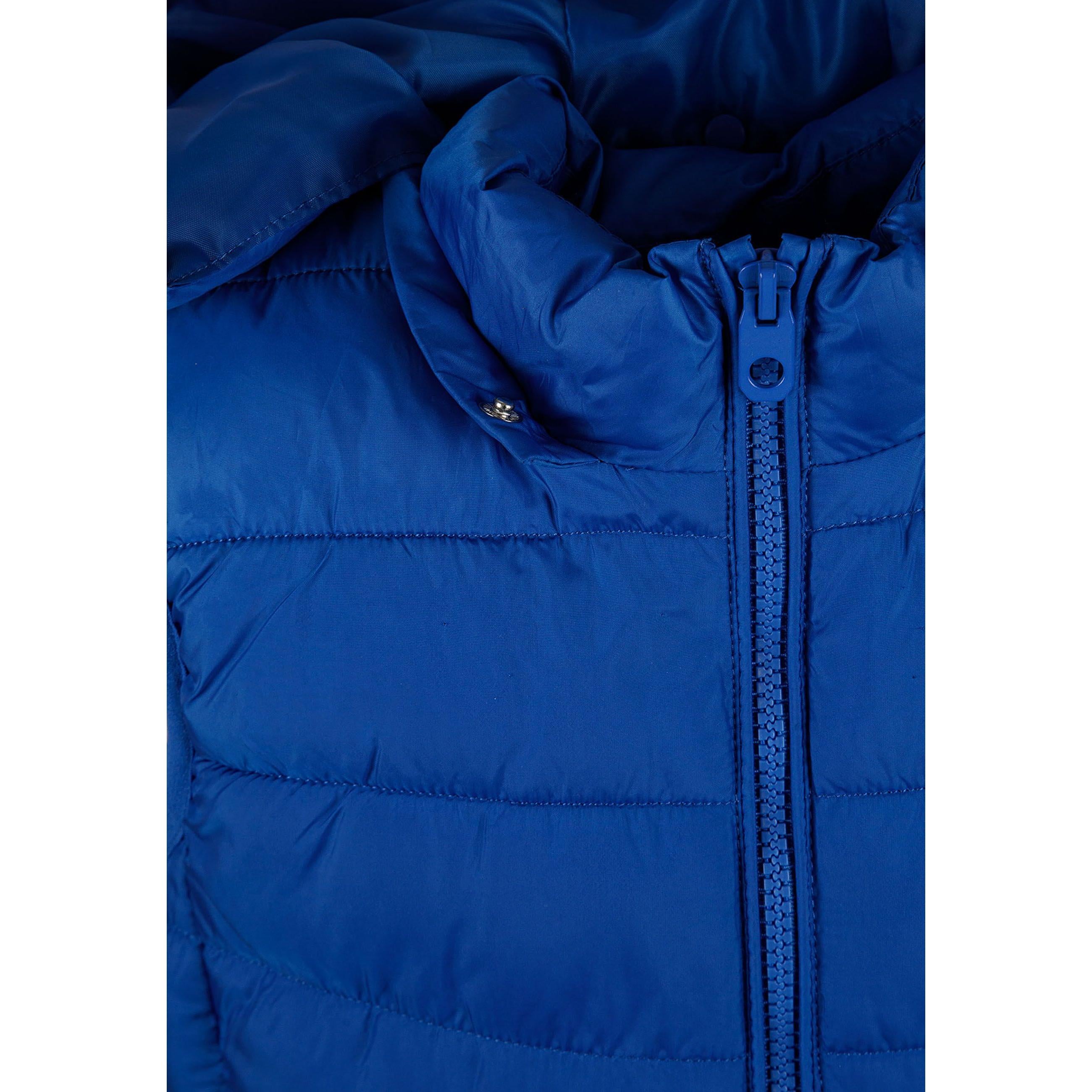 Close-up detail of cobalt blue padded gilet showing zip fastening, hood attachment and quilted texture