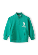 Green boys sweatshirt with half zip, kangaroo pocket, and printed detail. Perfect for ages 1-8 years, designed for casual wear.
