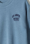 Boys sweatshirt and joggers set lightweight blue 1-8y featuring embroidered 'Los Angeles District' detail on soft cotton fleece.