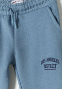 Boys joggers set lightweight blue with elasticated waistband and Los Angeles District print 1-8y. Perfect for casual wear.