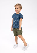 Cheerful boy in navy blue t-shirt with white prints and neck tape navy