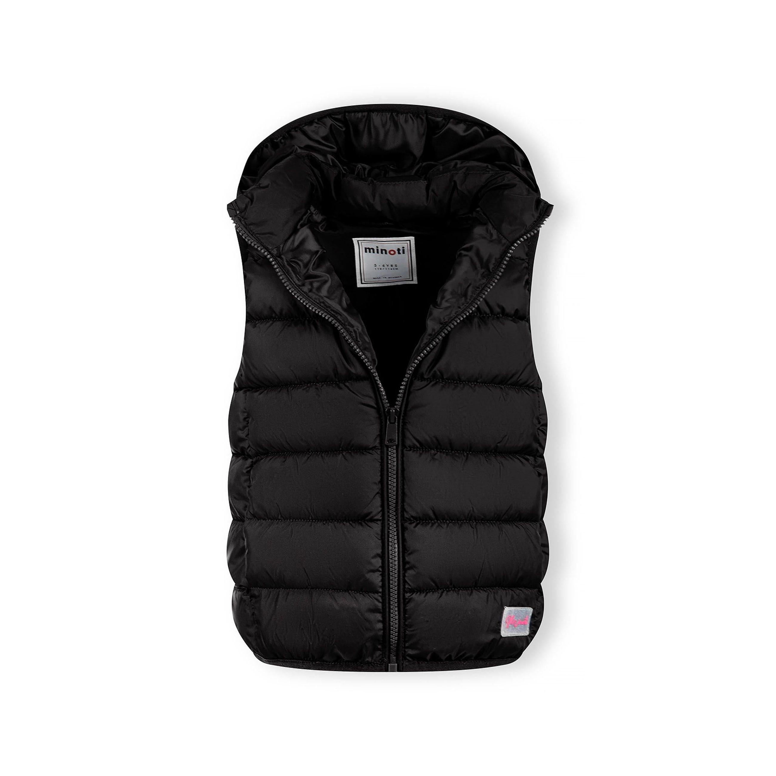 Black quilted gilet laid flat showing detachable hood, full zip front, Minoti label inside collar, and small logo patch at bottom hem