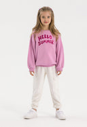 Girls fleece cargo joggers white 3-14y paired with a pink sweatshirt featuring 'HELLO SUMMER' print.
