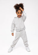 Young girl in gray heather girls hooded zip fleece jacket with joggers and sneakers