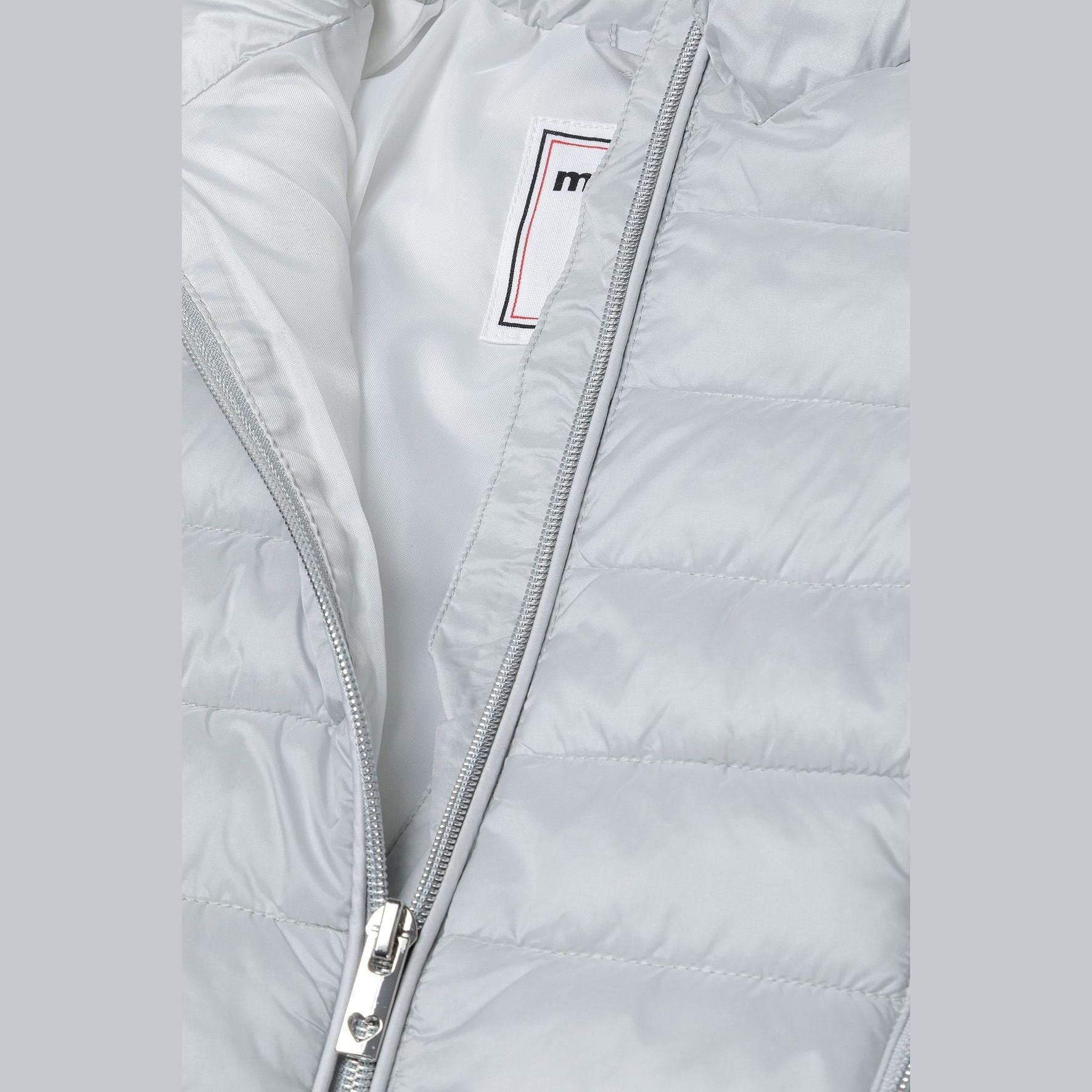 Close-up detail of silver-grey quilted jacket showing zip pocket with grey zipper pull and quilted texture