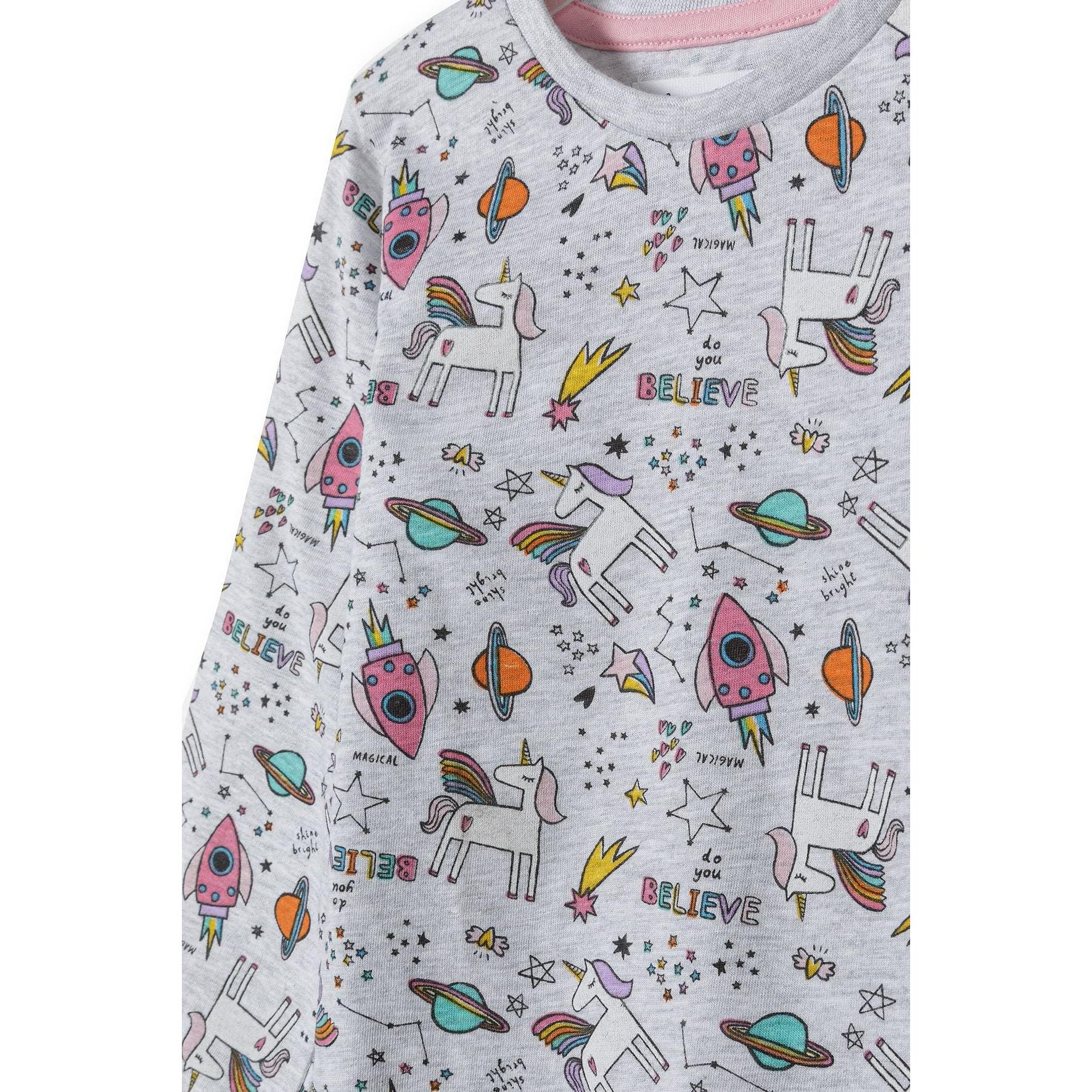 Close-up detail view of grey pyjama top showing colorful unicorn, rocket, planet and star print pattern with believe text and pink trim at neckline