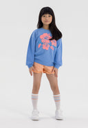 Peach girls poplin shorts with ruffle hem, elastic waist, and pink hibiscus sweatshirt