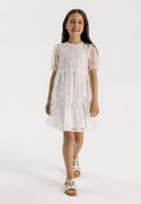 Girls short sleeve sequin flower dress white 3-14y. Lightweight white tulle with ruffle sleeves and sparkling sequins. Perfect for warm weather.