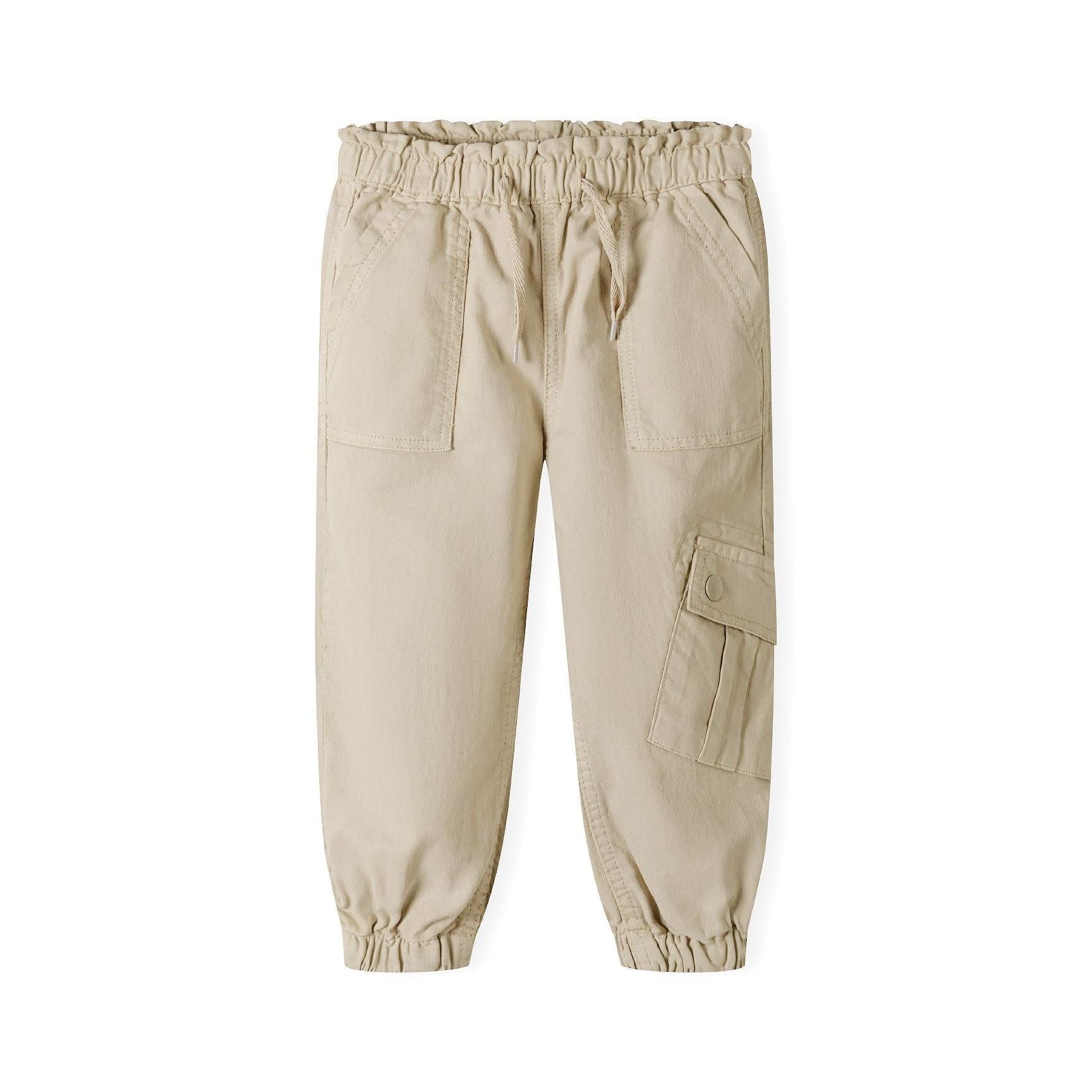 Back view of beige twill combat trousers showing elasticated paperbag waistband and cargo pocket details
