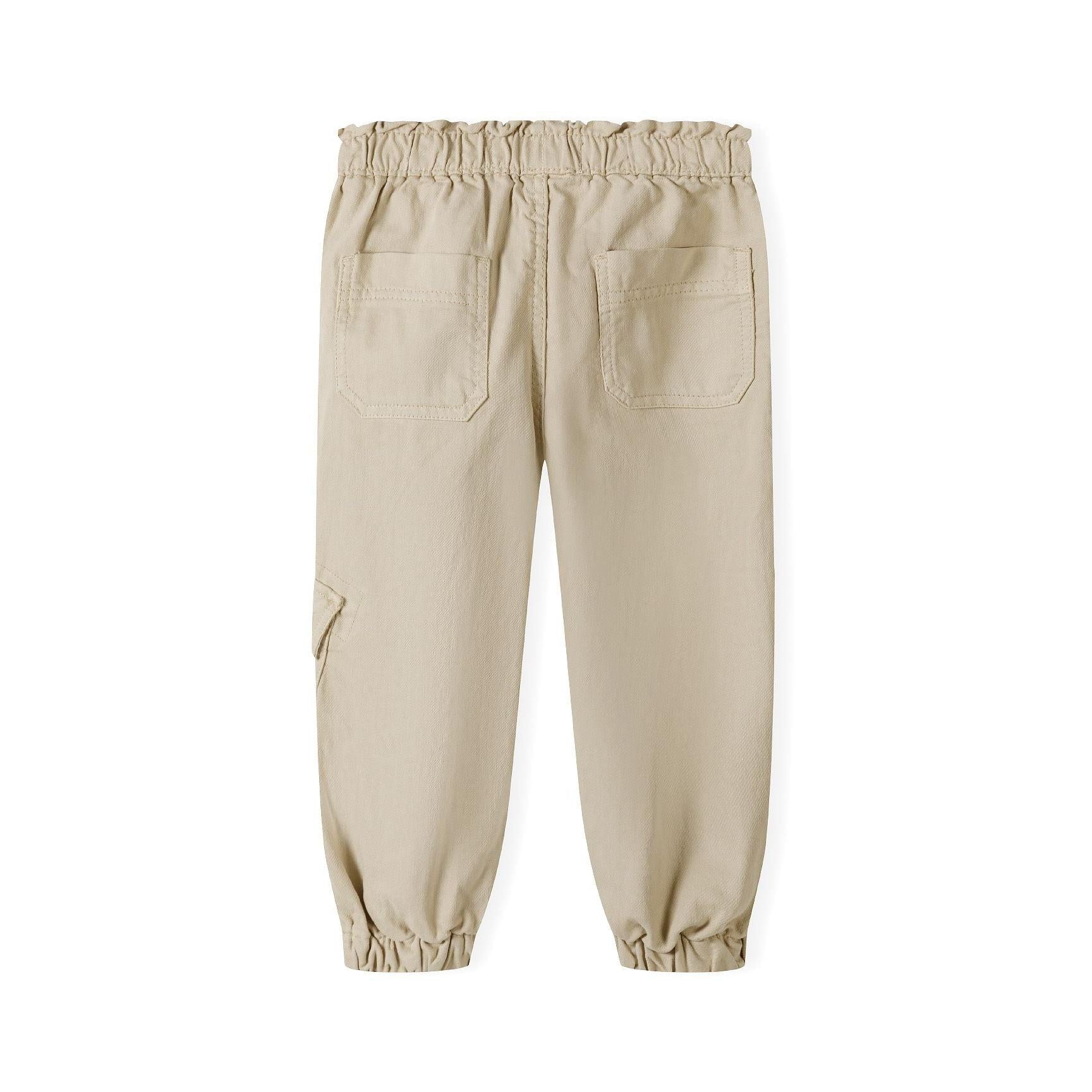 Back view of beige twill combat trousers showing elasticated paperbag waistband and cargo pocket details