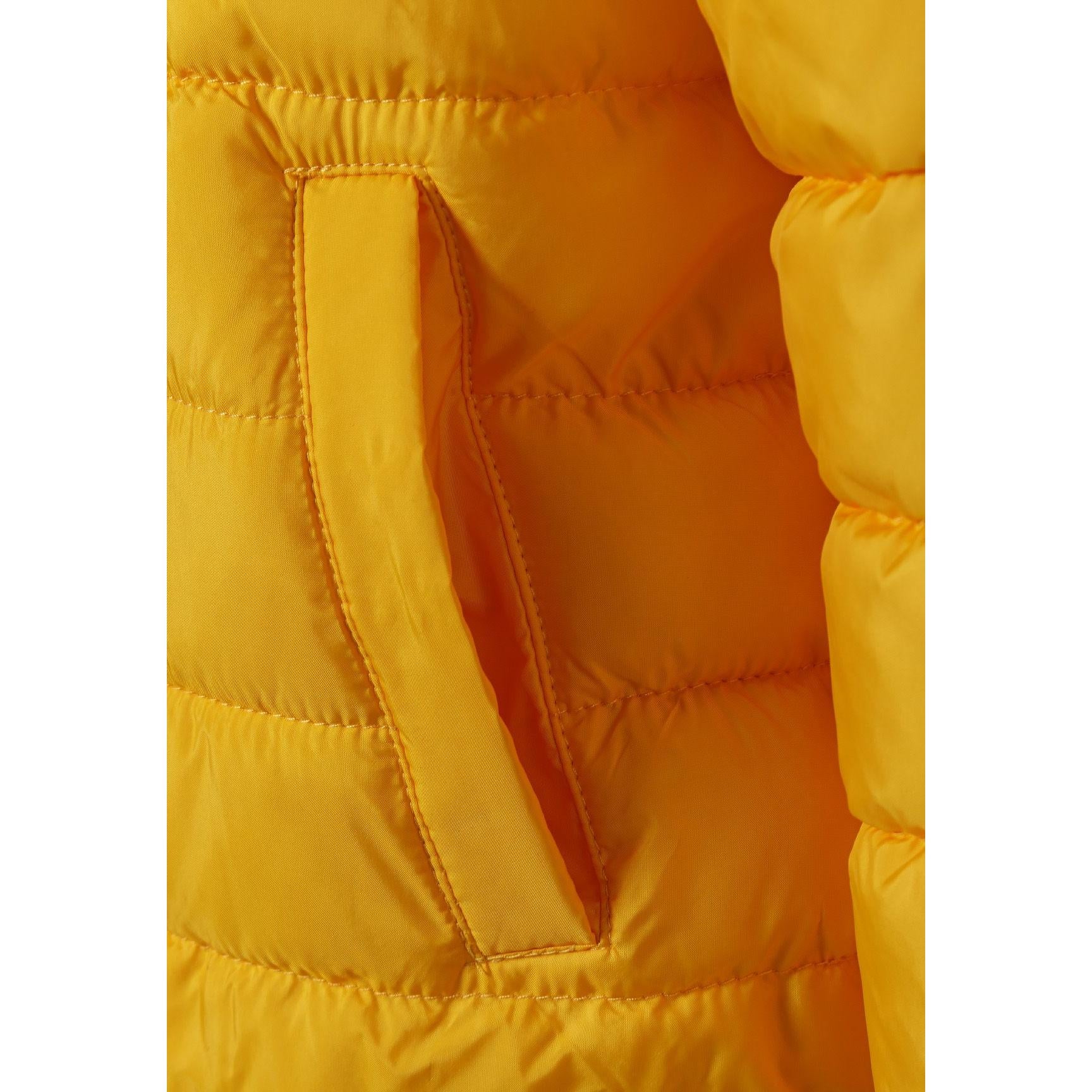 Close-up detail of yellow jacket showing zip closure, Minoti brand label, and quilted padding texture