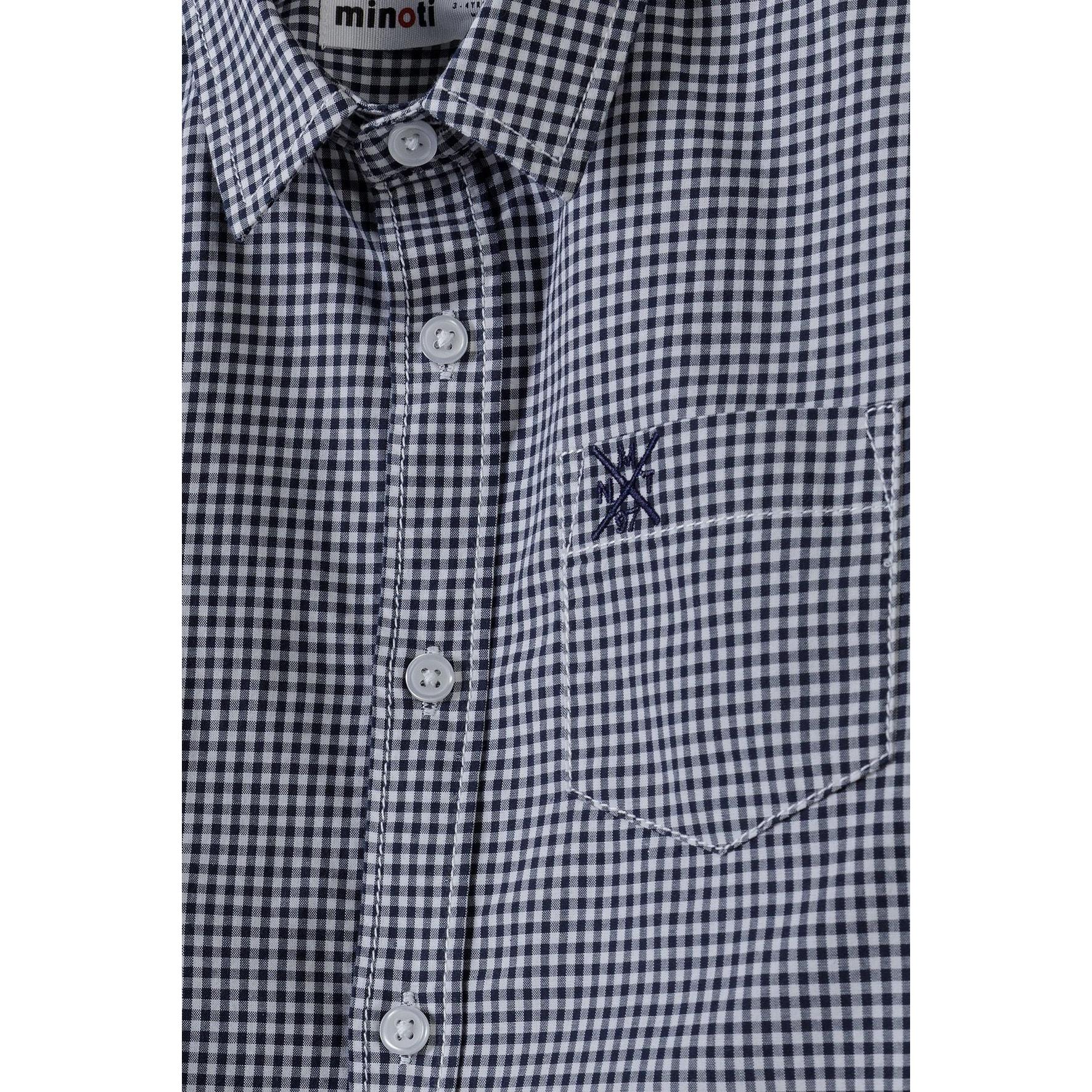 Close-up detail shot of the shirt showing Minoti label, button placket, embroidered chest pocket with small logo, and gingham check pattern
