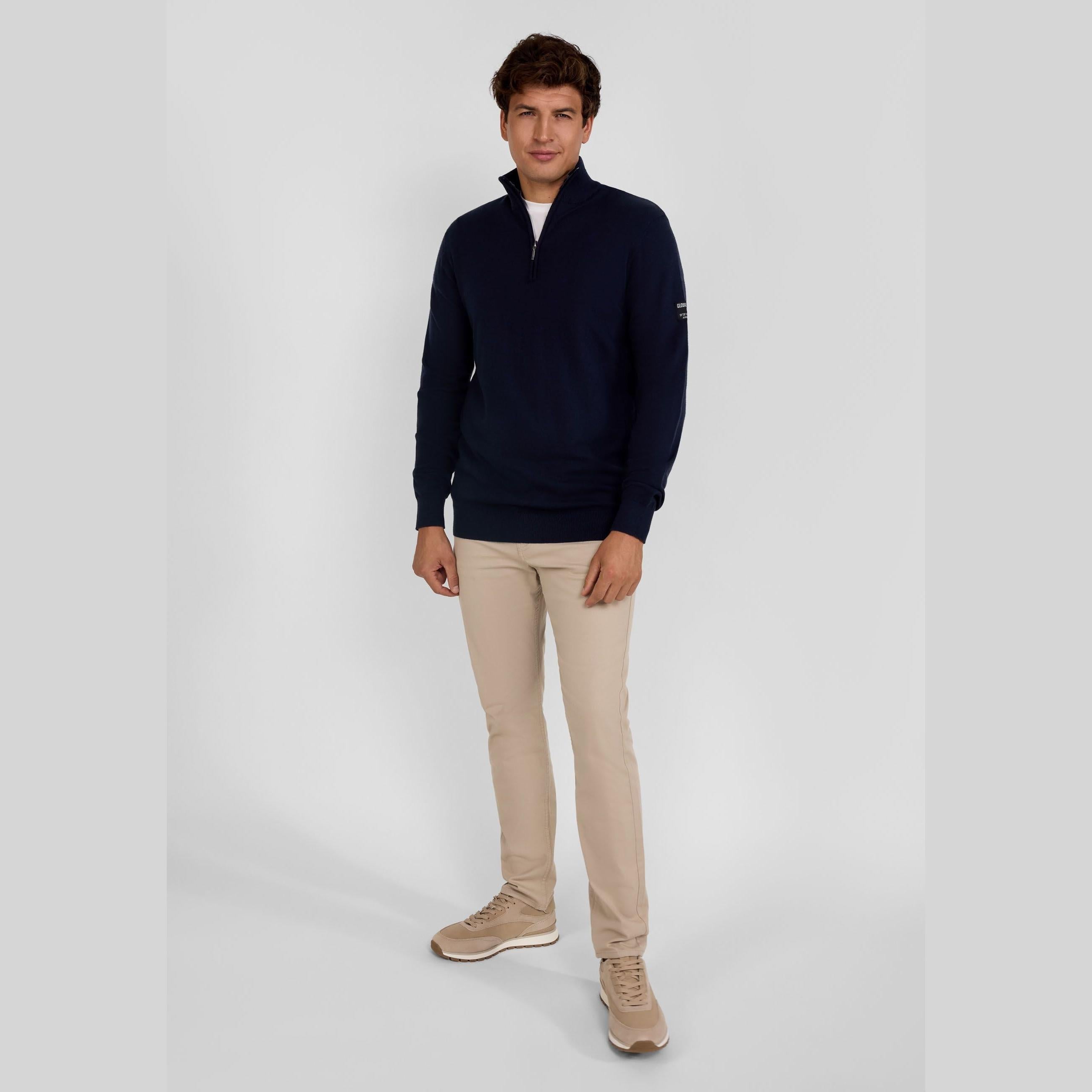 Men's navy half-zip jumper with adjustable collar, ribbed cuffs, and flexible hem.