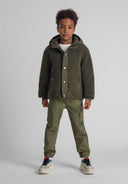 Olive green shearling-lined hooded jacket with woven cargo trousers