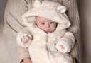 Soft cream-colored plush bear-themed baby onesie with fluffy texture and embroidered details.