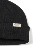 Black ribbed knit unisex beanie hat with Minoti Surplus label